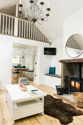 a living room with a fireplace and a table at Castle View in Lancaster