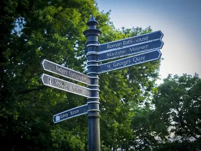 a street sign with many signs on a pole at Castle View in Lancaster