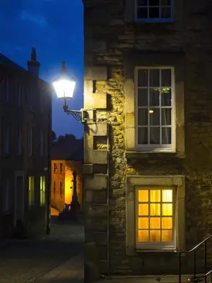 a street light on the side of a building at night at Castle View in Lancaster