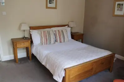 a bedroom with a large bed with two night stands at The Crown Hotel in Morecambe