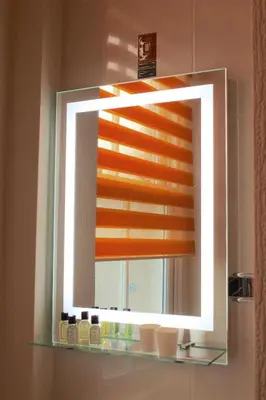 a bathroom mirror with a window in a bathroom at The Crown Hotel in Morecambe
