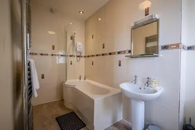 a bathroom with a sink and a bath tub and a sink at The Crown Hotel in Morecambe