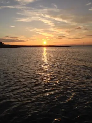 a sunset over a large body of water at The Crown Hotel in Morecambe