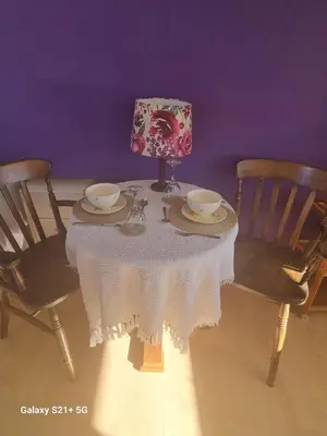 a table with two chairs and a white table cloth at The Gateway at Hest Bank in Lancaster