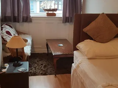 a bedroom with a bed and a table and a window at The Gateway at Hest Bank in Lancaster