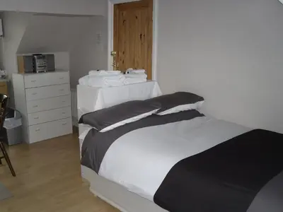 a bedroom with a bed with black and white sheets at The Gateway at Hest Bank in Lancaster