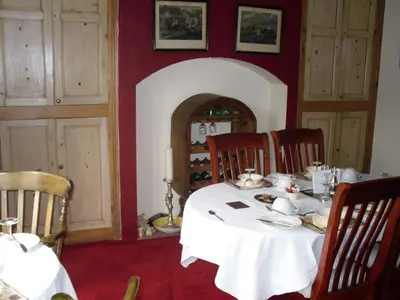 a dining room with a white table and chairs at The Gateway at Hest Bank in Lancaster