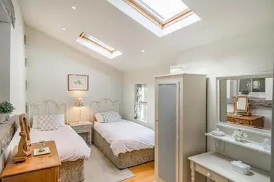 a bedroom with two beds and a mirror at 2 Beacon High in Lindale