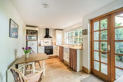 a kitchen with a wooden table and chairs and a table at 2 Beacon High in Lindale