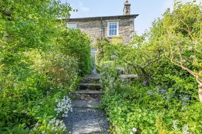 a stone house with stairs leading up to a house at 2 Beacon High in Lindale