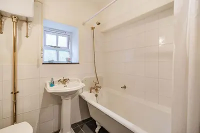 a white bathroom with a sink and a tub and a toilet at 2 Beacon High in Lindale