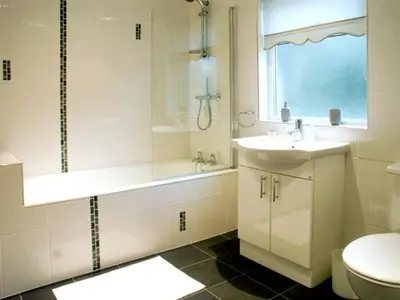 a bathroom with a sink and a shower and a toilet at Briarcliffe Cottage in Lindale