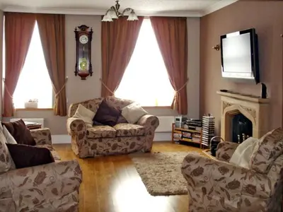a living room with two couches and a tv at Briarcliffe Cottage in Lindale