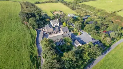 an aerial view of a large house in a field at Hill Side Barn in Ireleth