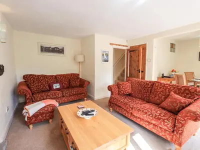a living room with a couch and a table at 4 Greencross Cottages in Holme