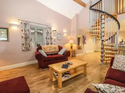a living room with a couch and a table at Eller Riggs Cottage in Ulverston