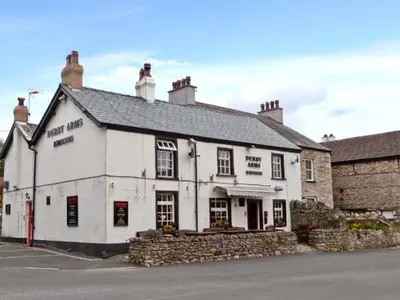 a white building sitting on the side of a street at The Crook in Great Urswick