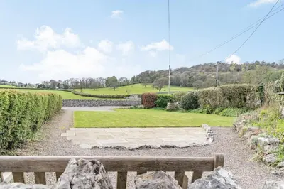 a view of a park with a bench at Pye Hall Cottage in Silverdale