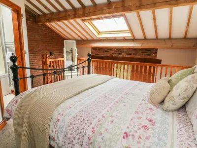 a bedroom with a bed in a room at Barn Owl Cottage At Crook Hall Farm in Mawdesley