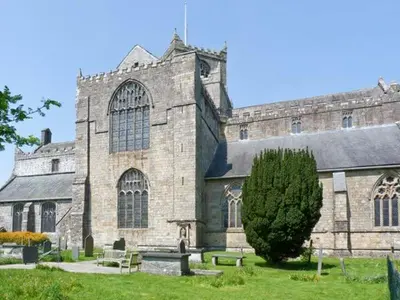 a large stone building with a tree in front of it at 2 Cark House in Holker