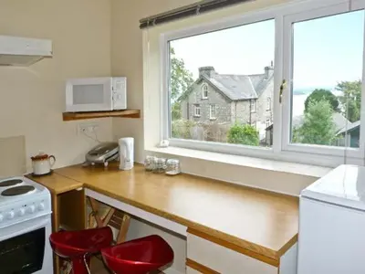 a kitchen with a counter and a large window at Baytree Apartment in Grange Over Sands