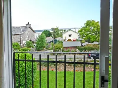 a view from a window of a house with a fence at Baytree Apartment in Grange Over Sands