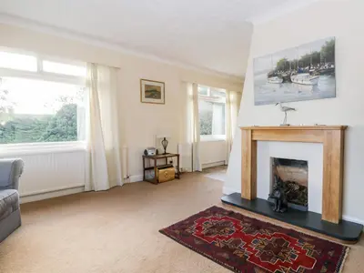 a living room with a fireplace and a couch at Silverdale Mount in Grange Over Sands