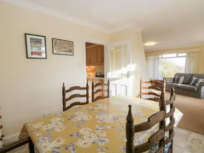 a kitchen and dining room with a table and chairs at Silverdale Mount in Grange Over Sands