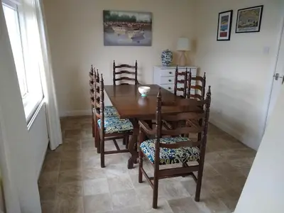 a dining room with a wooden table and chairs at Silverdale Mount in Grange Over Sands
