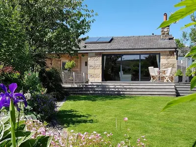 a small house with a yard with a lawn sidx sidx sidx at Stone Mouse Cottage in Harrop Fold