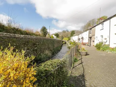 a garden path next to a fence and houses at 14 Low Row in Holker