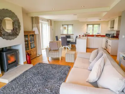a living room with a couch and a fireplace at Cottam Cottage Farm in Longridge