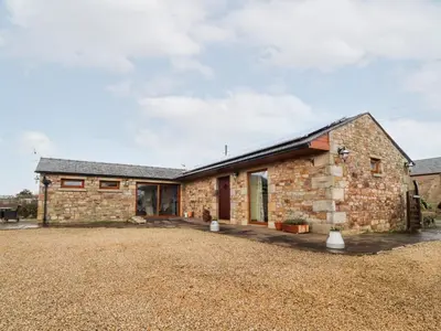 a stone house with a large yard at Deekswood in Pilling