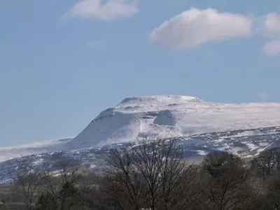 a mountain with snow on top of it at Bridleway Cottage in Wennington