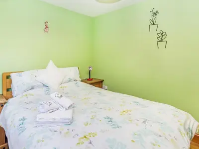 a bedroom with a bed with towels on it at Wild Duck Lodge in Rufford