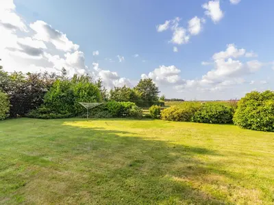 a large grassy yard with a basket in the middle at Wild Duck Lodge in Rufford