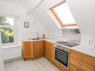 a kitchen with a sink and a stove at Eden Lodge in Bardsea