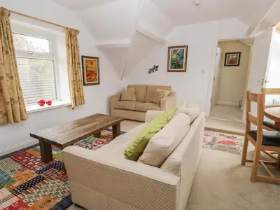 a living room with a couch and a table at Eden Lodge in Bardsea