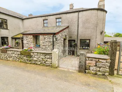 a stone house with a gate and a fence at Horrace Farm Cottage in Pennington