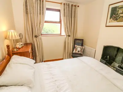 a bedroom with a white bed and a window at Horrace Farm Cottage in Pennington