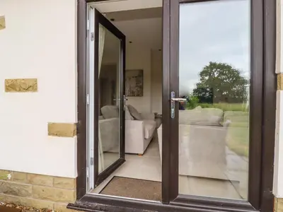 an open door with a view of a living room at Sunnyside Shreyas in Wilpshire