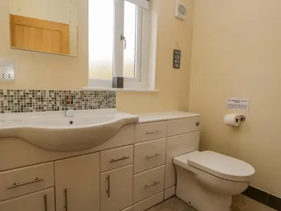 a bathroom with a sink and a toilet at Cartmel Lodge in Cartmel