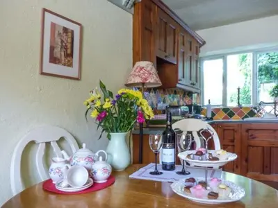 a kitchen with a table with a bottle of wine at High House in High Newton