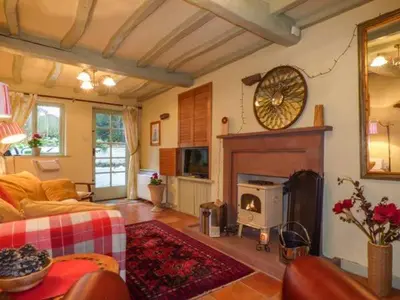 a living room with a couch and a fireplace at High House in High Newton