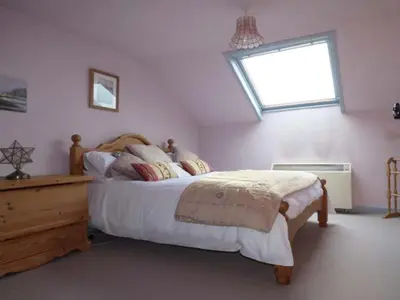 a bedroom with a large bed and a window at High House in High Newton