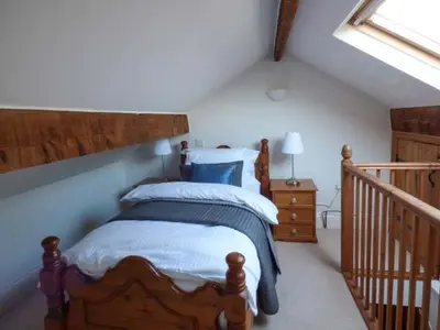 a bedroom with a bed in a attic with a window at 88 Regent Street in Waddington