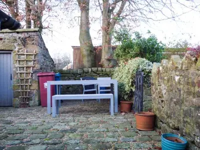 a white bench sitting on a stone patio at 88 Regent Street in Waddington