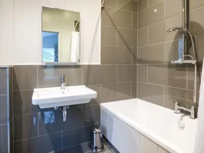 a bathroom with a sink and a mirror at Shepherd Lodge in Cartmel