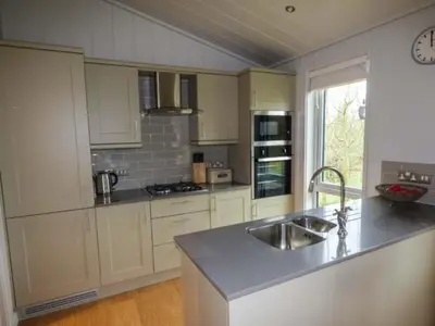 a kitchen with a sink and a counter top at Shepherd Lodge in Cartmel