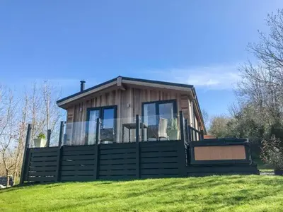 a small house on top of a grassy hill at Crook Lodge in Cartmel